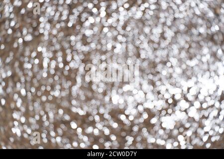 Twinkle wet beach sand. Brown and white bokeh of sand water and sun light. Texture, background and pattern Stock Photo