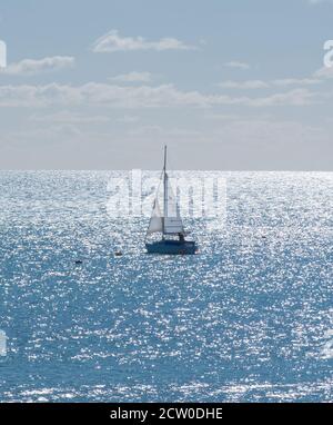 Lyme Regis, Dorset, UK. 26th September 2020. UK Weather: A sailing boat makes the best of the better weather at Lyme Regis as rain and high winds clear making way for a bright and sunny weekend.  Credit: Celia McMahon/Alamy Live News. Stock Photo