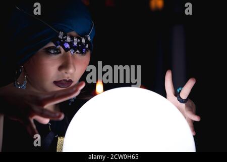 Fortune teller forecast future event or destiny by using crystal ball. Stock Photo