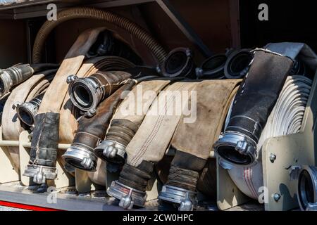 Rescue fire truck equipment. Compartment of the rolled up fire hoses on a fire engine Stock Photo