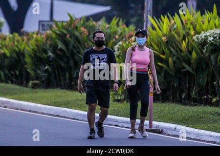 Manila, Philippines. 26th Sep, 2020. People wearing face masks walk in Manila, the Philippines, Sept. 26, 2020. The number of confirmed COVID-19 cases in the Philippines surged to 301,256 with 2,747 new coronavirus infections reported by the health ministry on Saturday. Credit: Rouelle Umali/Xinhua/Alamy Live News Stock Photo