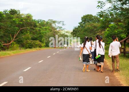 Back view of a group of Laotian high school walking home from school, rural scene in South Laos. Stock Photo