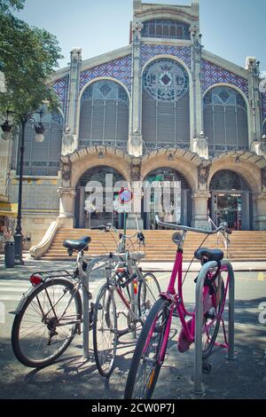 Valencia, Spain - July 23, 2020: Bicycles parked in front of the historic central market building in Valencia Stock Photo