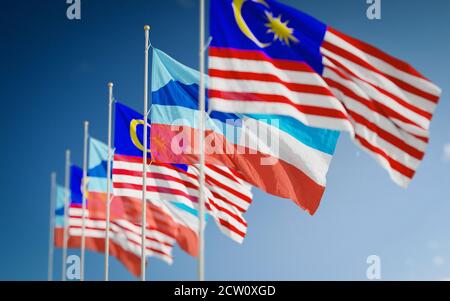 Waving flags of Borneo Sabah State and Malaysia against a beautiful sky background Stock Photo