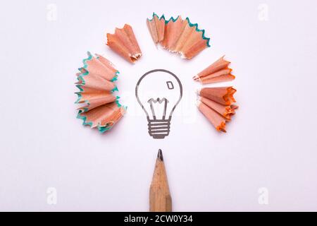 A light bulb surrounded by sharpener waste and a pencil as a symbol of creativity Stock Photo