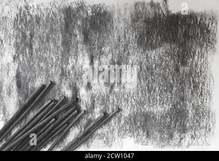 Black grunge coal ink sheet of paper background and crayons Stock Photo