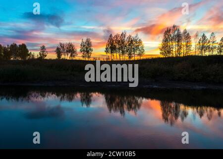 Beautiful sunset with amazing sky over the river. Landscape Stock Photo