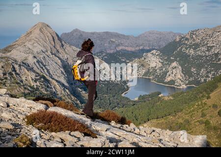 trekker in front of the Gorg Blau reservoir, Escorca, Mallorca, Balearic Islands, Spain Stock Photo