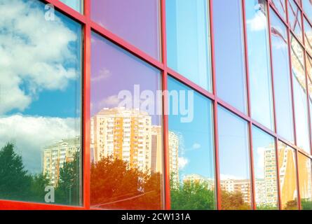 Buildings reflected in the glass of another building in sunny day Stock Photo