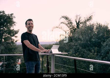 Shallow focus shot of a young caucasian using his tablet Stock Photo