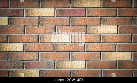 Old grunge brick wall texture with delicate vignetting. Stock Photo