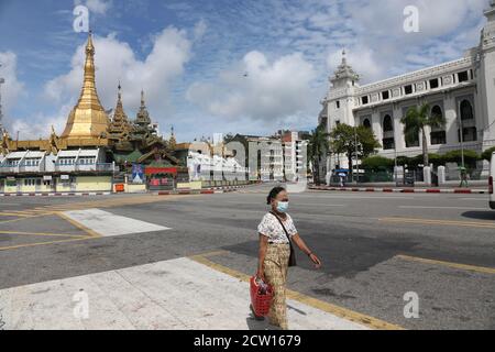 Yangon, Myanmar. 26th Sep, 2020. A woman wearing a mask walks in downtown Yangon, Myanmar, Sept. 26, 2020. The number of COVID-19 infection cases in Myanmar reached 9,991 on Saturday night, said a release from the Health and Sports Ministry. According to the release, Myanmar reported 880 new confirmed cases and 24 more deaths on Saturday night. Credit: U Aung/Xinhua/Alamy Live News Stock Photo