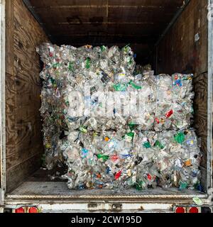 Bundles of crushed plastic bottles being transported for recycling, New Jersey, USA Stock Photo