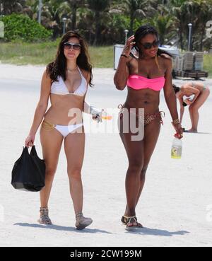 MIAMI BEACH, FL - APRIL 16:  Tennis great Serena Williams took a break from her rehab efforts with a day at the beach.  The 29-year-old hit Sobe with friends and ate some lunch on the beach and got a foot message  before taking a dip in the ocean wearing a two piece swimsuit with a pink top and leopard print bottom.  on April 16, 2011 in Miami Beach, Florida   People:  Serena Williams Stock Photo