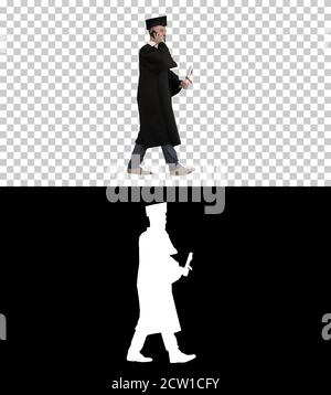 Graduating student walking and making a call, Alpha Channel with Stock Photo