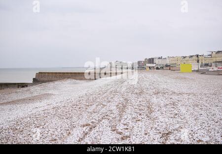 A cold morning on Brighton beach, with snow on the pebbles Stock Photo