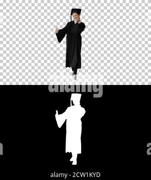 Happy female graduate in mortarboard making selfie on her phone, Stock Photo