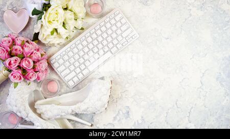 White aesthetic wedding bridal theme desktop workspace with high heel shoes, bouquets and accessories on stylish white textured background. Top view b Stock Photo