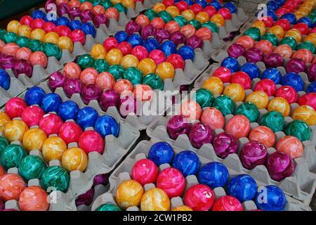 Closeup of colorful painted Easter eggs in boxes on the table Stock Photo