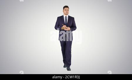 Handsome experienced manager writing in notebook his ideas while Stock Photo