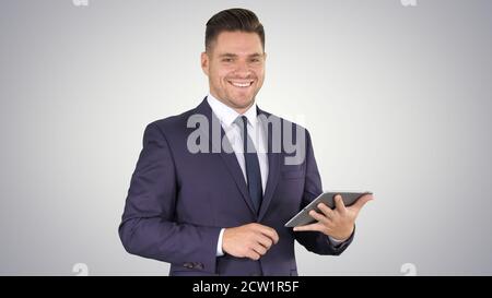 Expressive young businessman with tablet presenting something sw Stock Photo