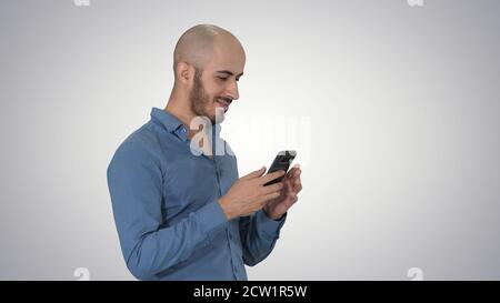 Casual arabic businessman using the phone and smiling on gradien Stock Photo