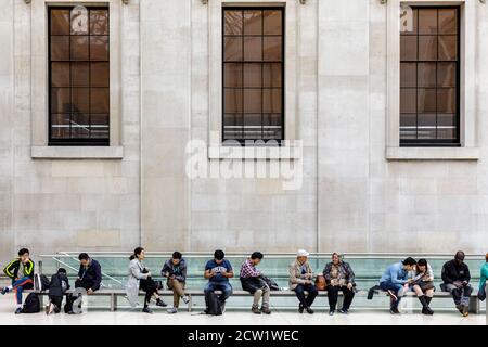 Visitors to the British Museum relax in the Great Court, London, United Kingdom.