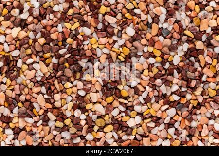Multi-colored small river stones texture and background. Stock Photo