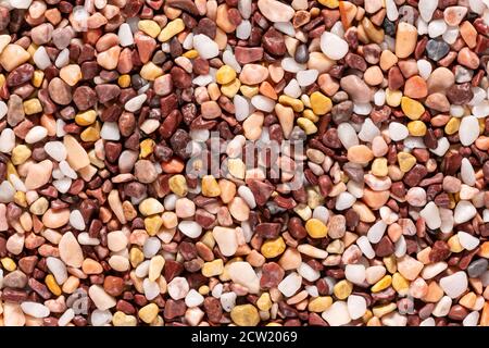Multi-colored small river stones texture and background. Stock Photo