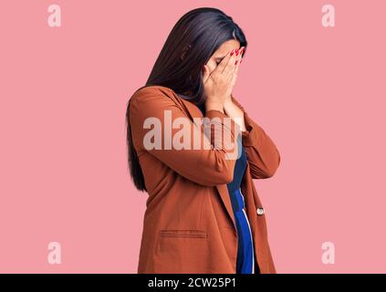 Young beautiful brunette woman wearing elegant clothes with sad expression covering face with hands while crying. depression concept. Stock Photo