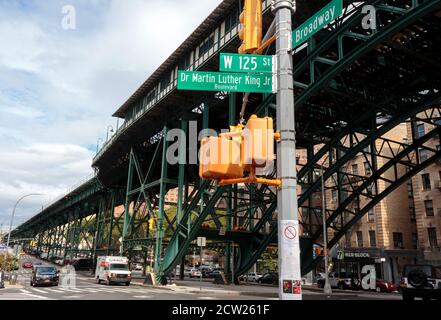 Street scene under the elevated subway station tracks at w 125th street and Broadway in Harlem Stock Photo