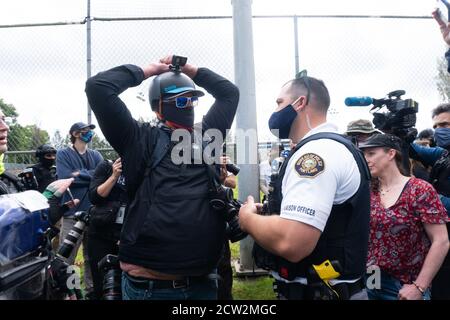 Portland, Oregon, USA. 26th September, 2020. Portland Police talking with the man during the End to Domestic Terrorism Rally in support of Kenosha shooter Kyle Rittenhouse and Aaron 'Jay' Danielson who was shot dead by an antifascist protester during the ongoing Black Lives Matter protests in the city. Credit: Albert Halim/Alamy Live News Stock Photo