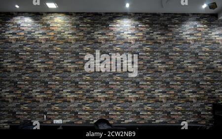The texture of the colorful brick wall of many rows of bricks. Stock Photo