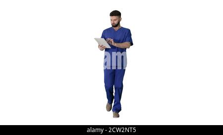 Confident concentrated focused surgeon using digital tablet on w Stock Photo