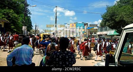 DISTRICT KATNI, INDIA - AUGUST 08, 2019: Indian people waiting for school students traffic clearance on road. Stock Photo