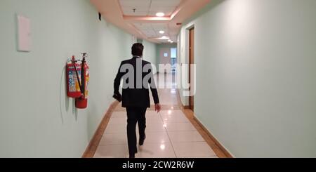 CITY DELHI, INDIA - JANUARY 25, 2020: An Indian professional man going for attending for company annual event at Thyagaraj Sports Complex in delhi. Stock Photo