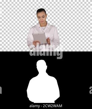 Doctor using tablet while walking, Alpha Channel Stock Photo