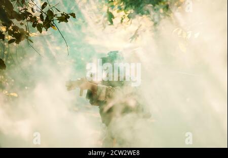 Fully Equipped Soldiers Wearing Camouflage Uniform Attacking Enemy, Airsoft military game player in camouflage uniform Stock Photo