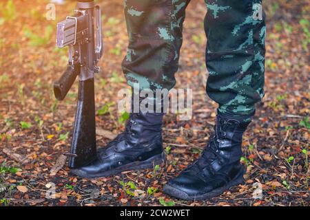 Gun on foot Army, Military Boots lines of commando soldiers in camouflage uniforms Thailand Stock Photo