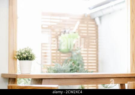 Empty of Wooden table on defocused summer window with flower pot background Stock Photo