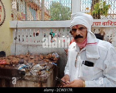 DISTRICT KATNI, INDIA - JULY 08, 2020: Indian traditional man worshiping at hindu religious place while travel. Stock Photo