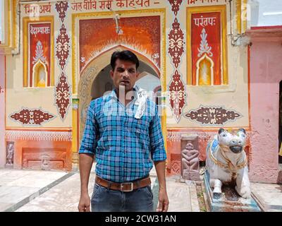 DISTRICT KATNI, INDIA - JULY 08, 2020: indian village boy standing alone at hindu holy temple, tour and travel with family concept. Stock Photo