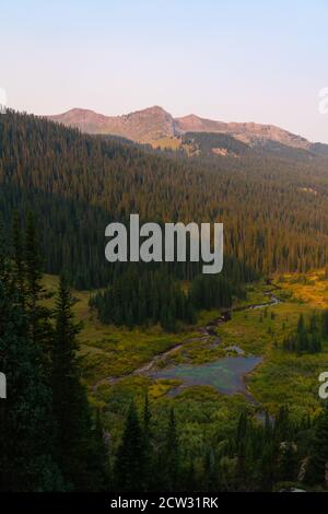Vertical view of the valley along the Four Pass Loop in Colorado during sunrise. Stock Photo