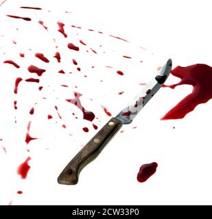 A knife is covered with a fresh blood. Isolated on white