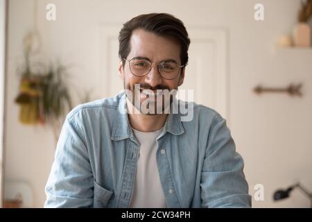 Headshot of smiling man talk on video call at home Stock Photo