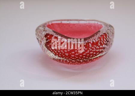 Isolated Italian bullicante technique Murano glass vintage colored decoration object on white background. Artistic vivid colored light retro crystal. Stock Photo