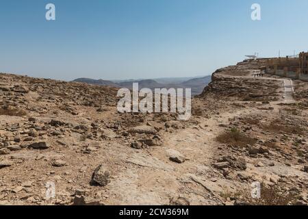 the promenade at makhtesh ramon crater near the visitor center in Mitzpe Ramon in Israel showing tourists and an observation deck in the background Stock Photo