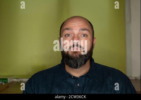 Man looks sad and thoughtful into the camera Stock Photo