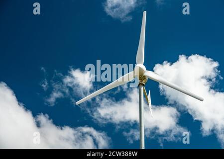 Close view of a wind turbine with blue sky. Stock Photo