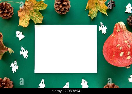 Autumn composition. Pumpkins,dried leaves and decorative ghoasts background. Paper blank template autumn, fall, halloween, harvest thanksgiving Stock Photo